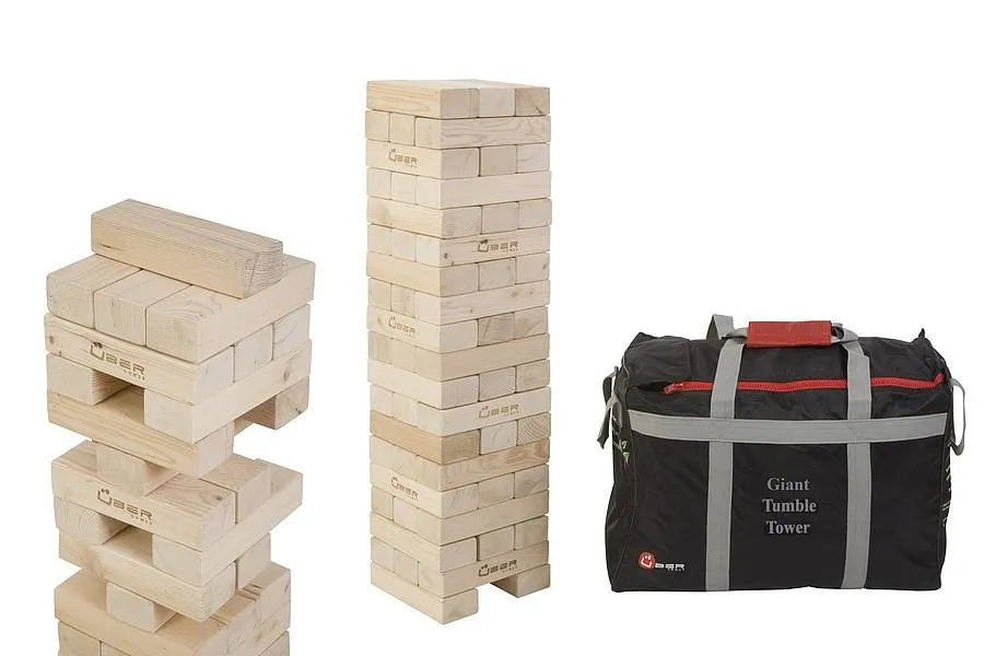 Two giant tumbling towers and a black bag on a white background.