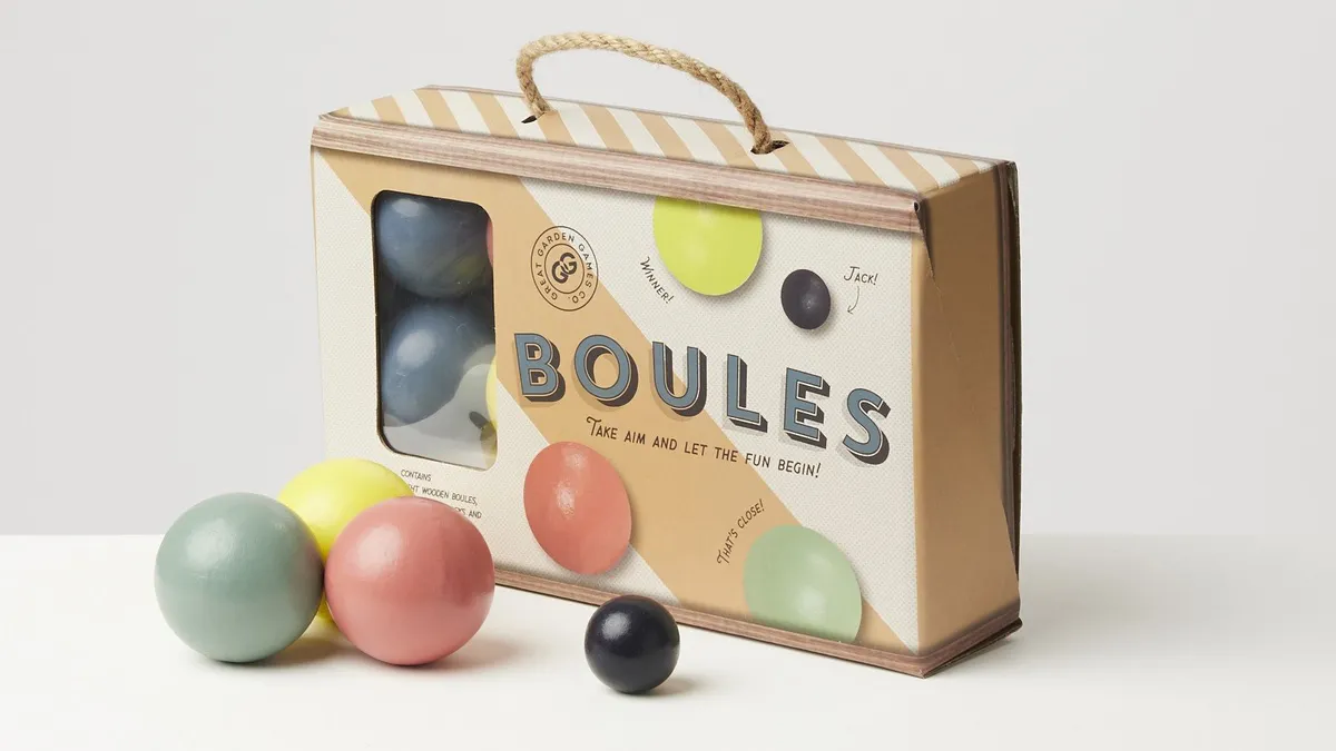A box of boules with four balls in front.