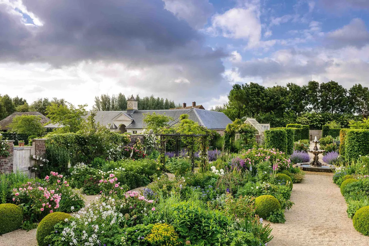 Cutting flowers and organic produce for the kitchen sit happily together in an attractive walled garden that extends in an easterly aspect from the rose garden. At the far end, a glasshouse provides warmth for bringing on early crops.