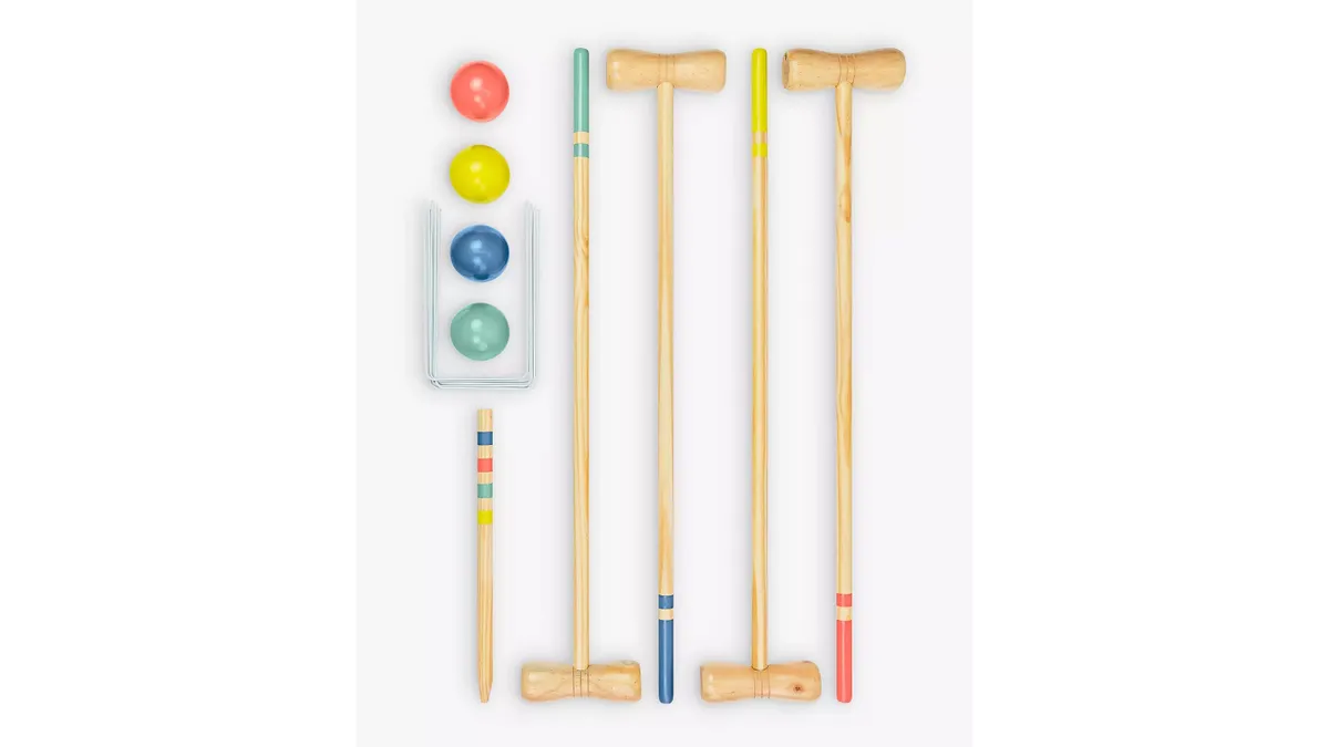 A croquet set with four mallets, four balls, wire hoops and a multi-coloured post.