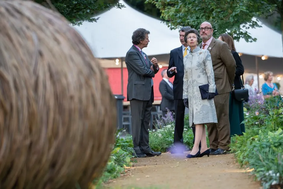 Anne, Princess Royal talks with designer David Dodd on RHS Queen's Green Canopy Garden designed by Dodd during press day at RHS Chelsea Flower Show 