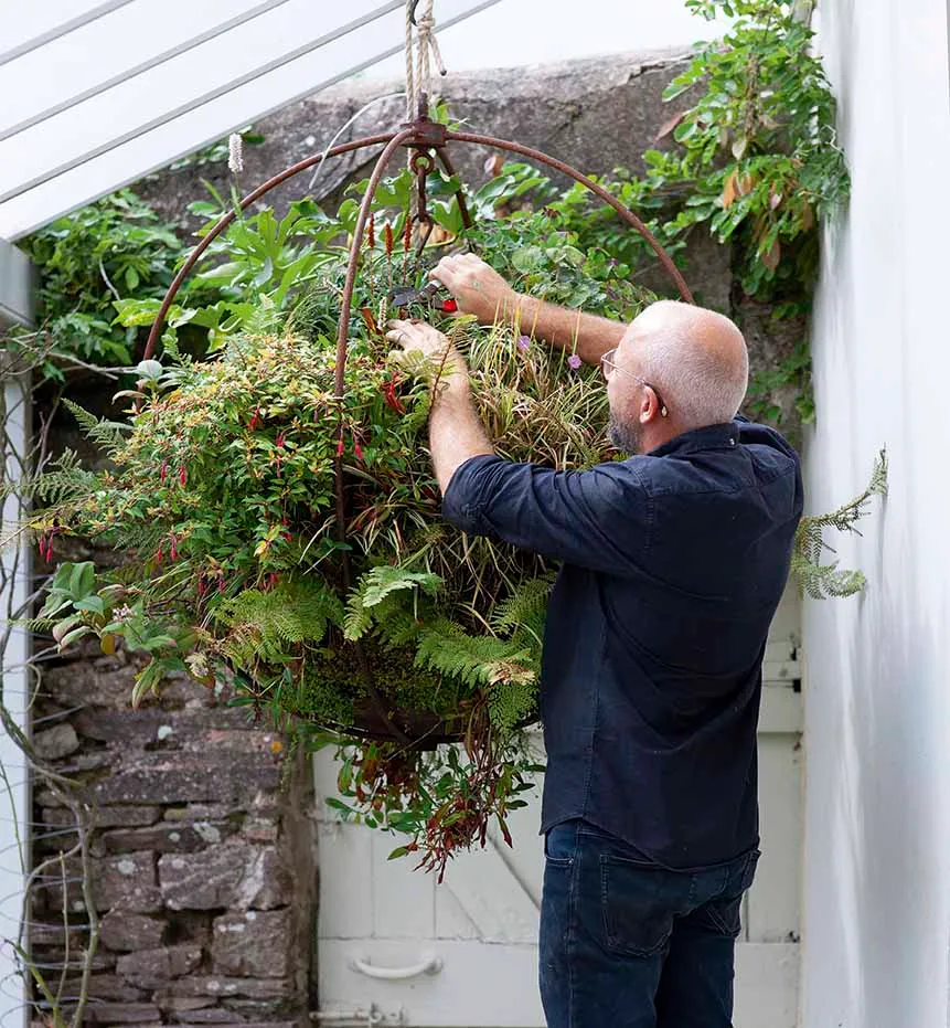 Adam Shepherd tending to a bespoke hanging planter