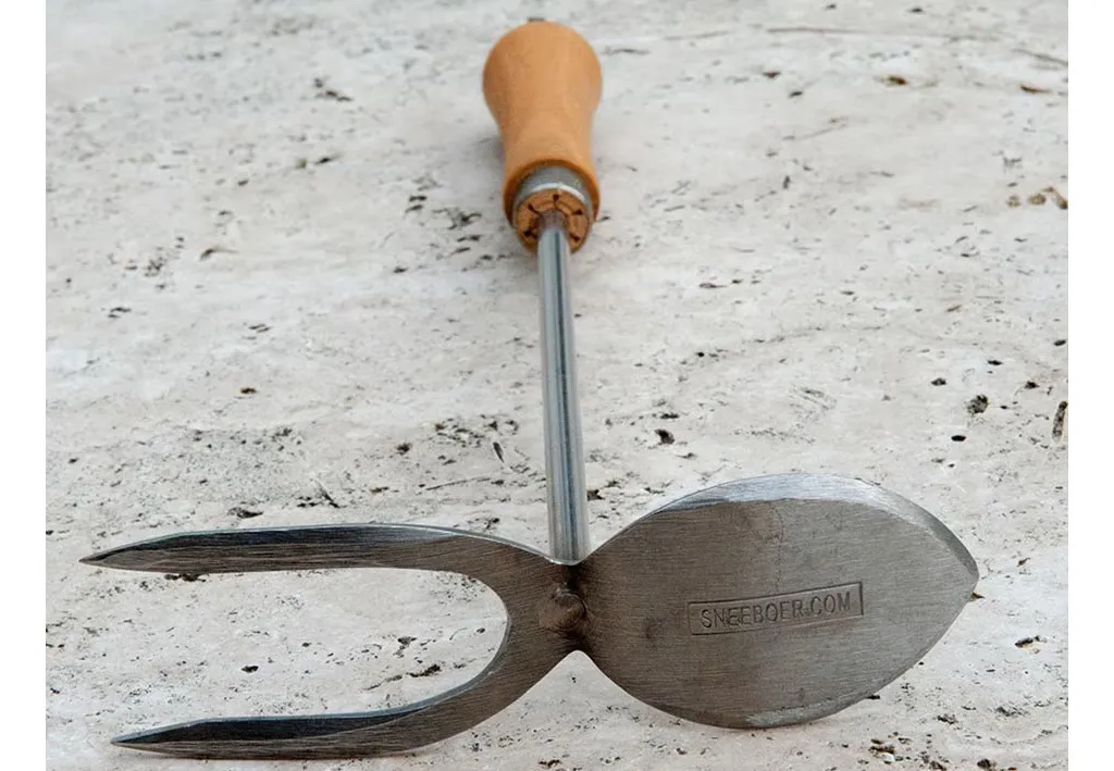 Sneeboer hand mattock on a marble table