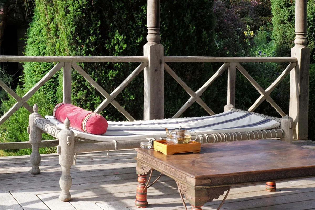 The Daybed Company wooden day bed on a terrace