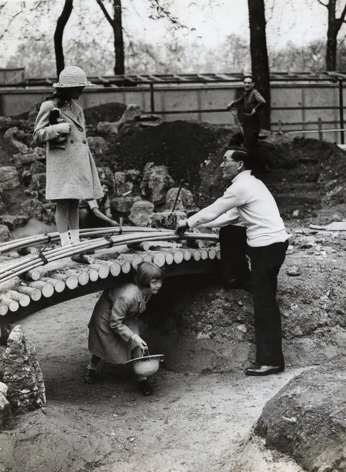 Children with Seyomon Kusumoto at the RHS Chelsea Flower Show. Date: 1936.