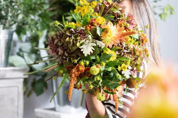 Woman holding bouquet in a flower shop