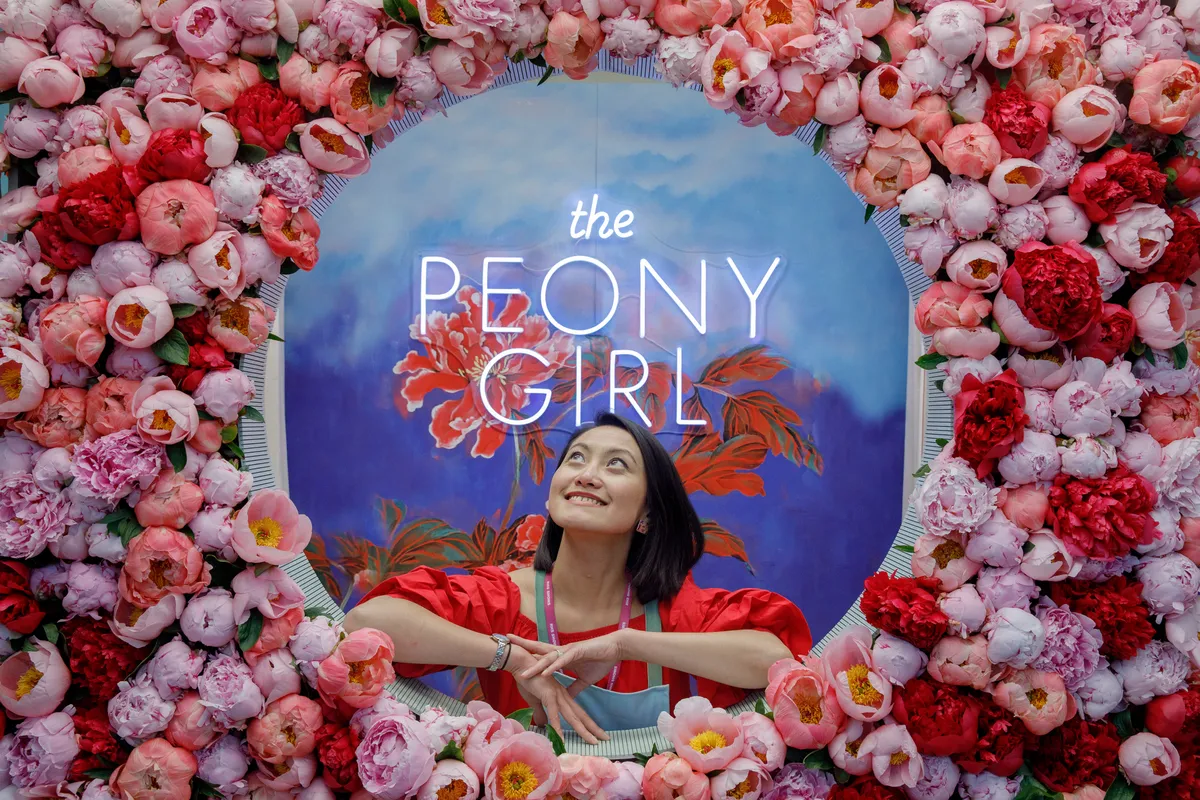 Exhibitor Siyuan Ren poses on the Peony Girl exhibition in 2022