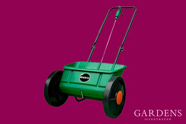 Miracle-Gro Lawn Seed Drop Spreader on a pink background