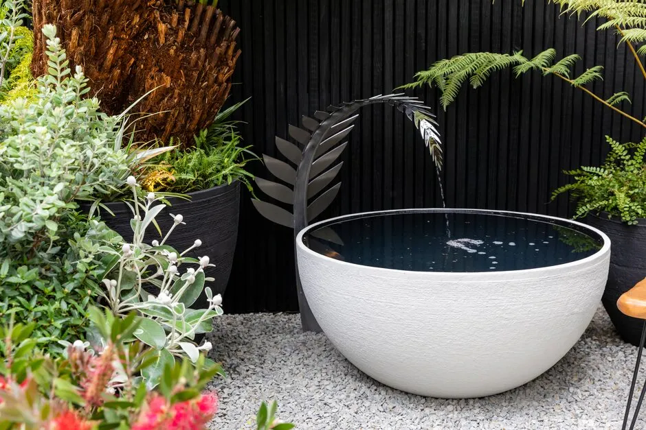 Water feature on the Feels Like Home. Designed by Rosemary Coldstream. Container Garden. RHS Chelsea Flower Show 2023.