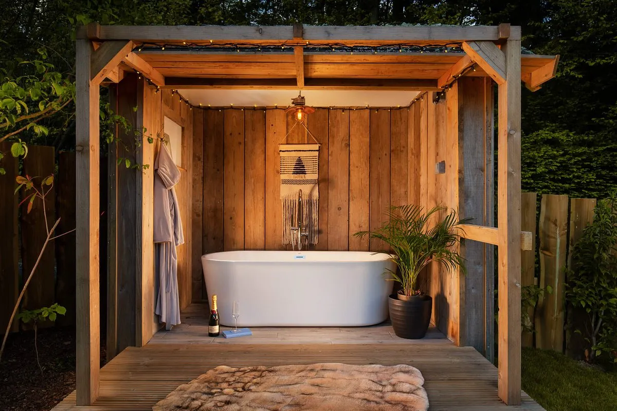 A bath tub in an outdoor covered area at Hinton Hideaways, Somerset