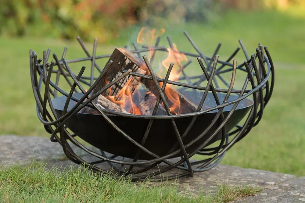 Nest iron fire pit bowl in a garden