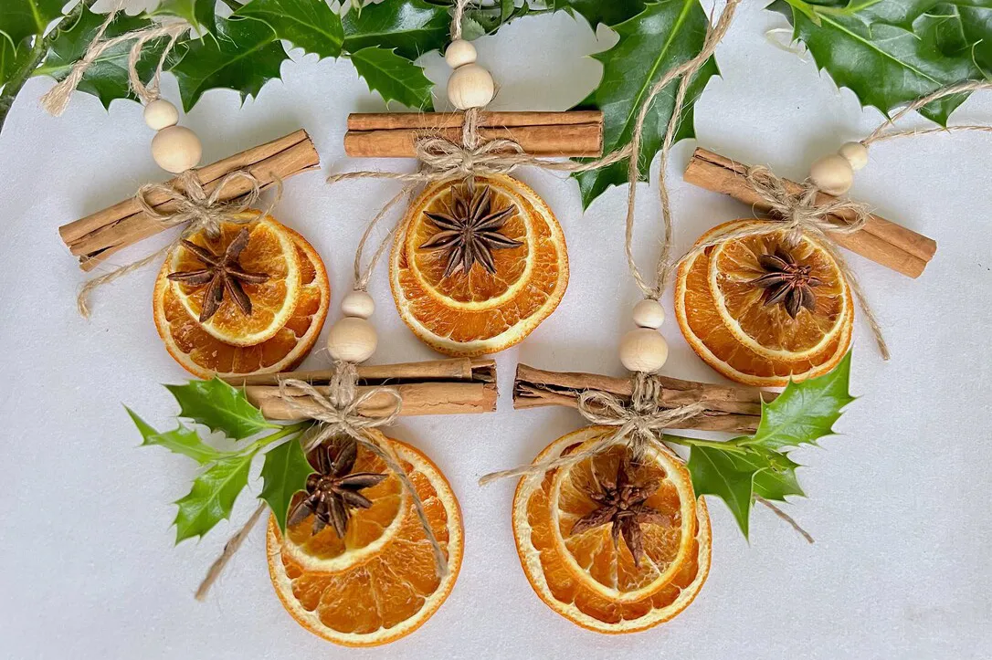 Dried Orange, Cinnamon, Star Anise natural Christmas Decorations on a white table