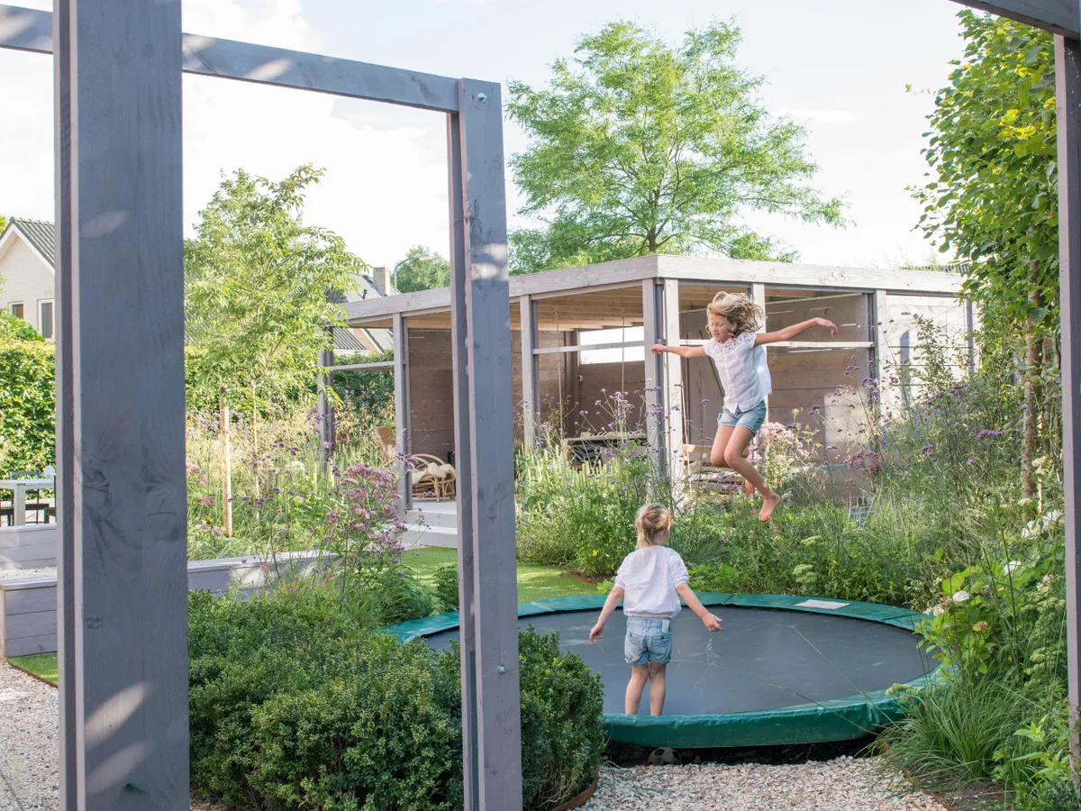 Submerged trampoline in a family garden designed by Carrie Preston