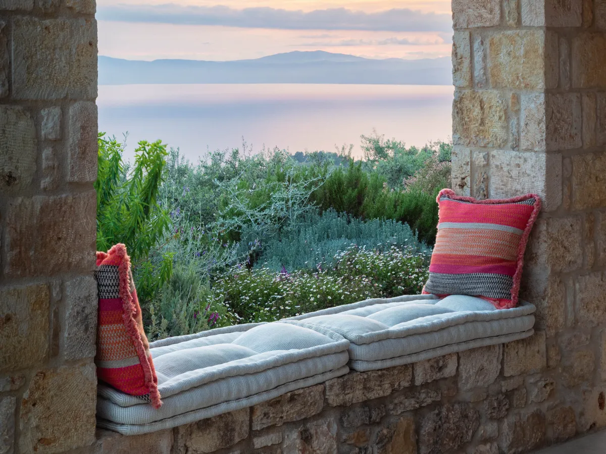 Window seat looking out to sea at Ilias Estate, Greece, designed by Tania Compton.