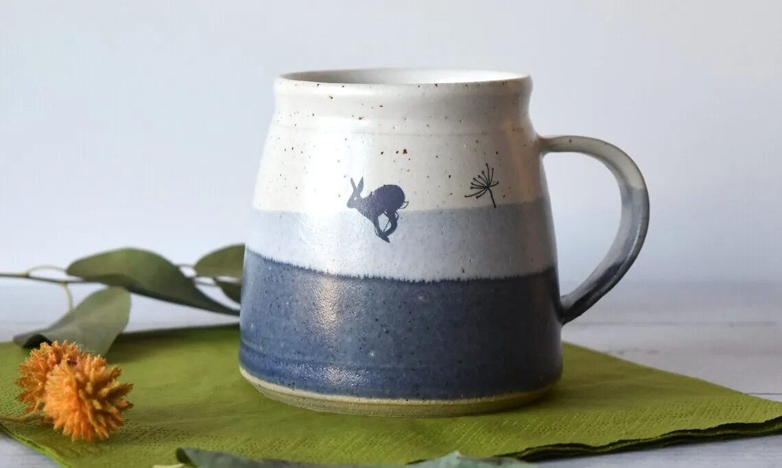 Ceramic mug with bunny hare on a table