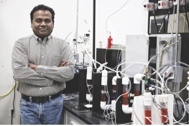 Dr Pratap C Pullammanappallil with a device to turn faeces into fuel © Amy Stuart/UF IFAS Communications