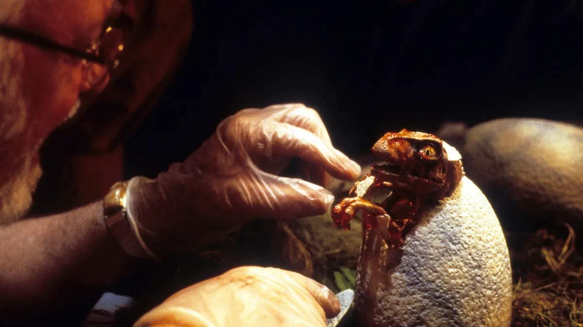 Richard Attenborough hatches a baby dinosaur in a scene from the film 'Jurassic Park', 1993 © Universal/Getty Images