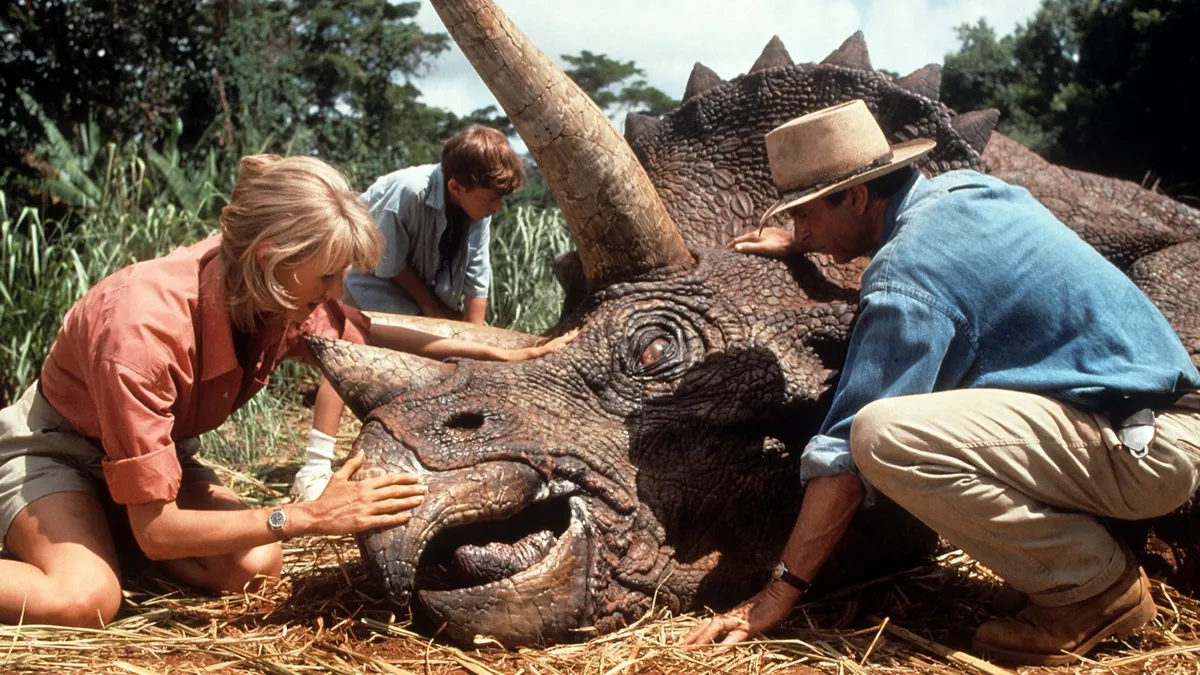 Laura Dern and Sam Neill come to the aid of a triceratops in a scene from the film 'Jurassic Park', 1993 © Universal/Getty Images