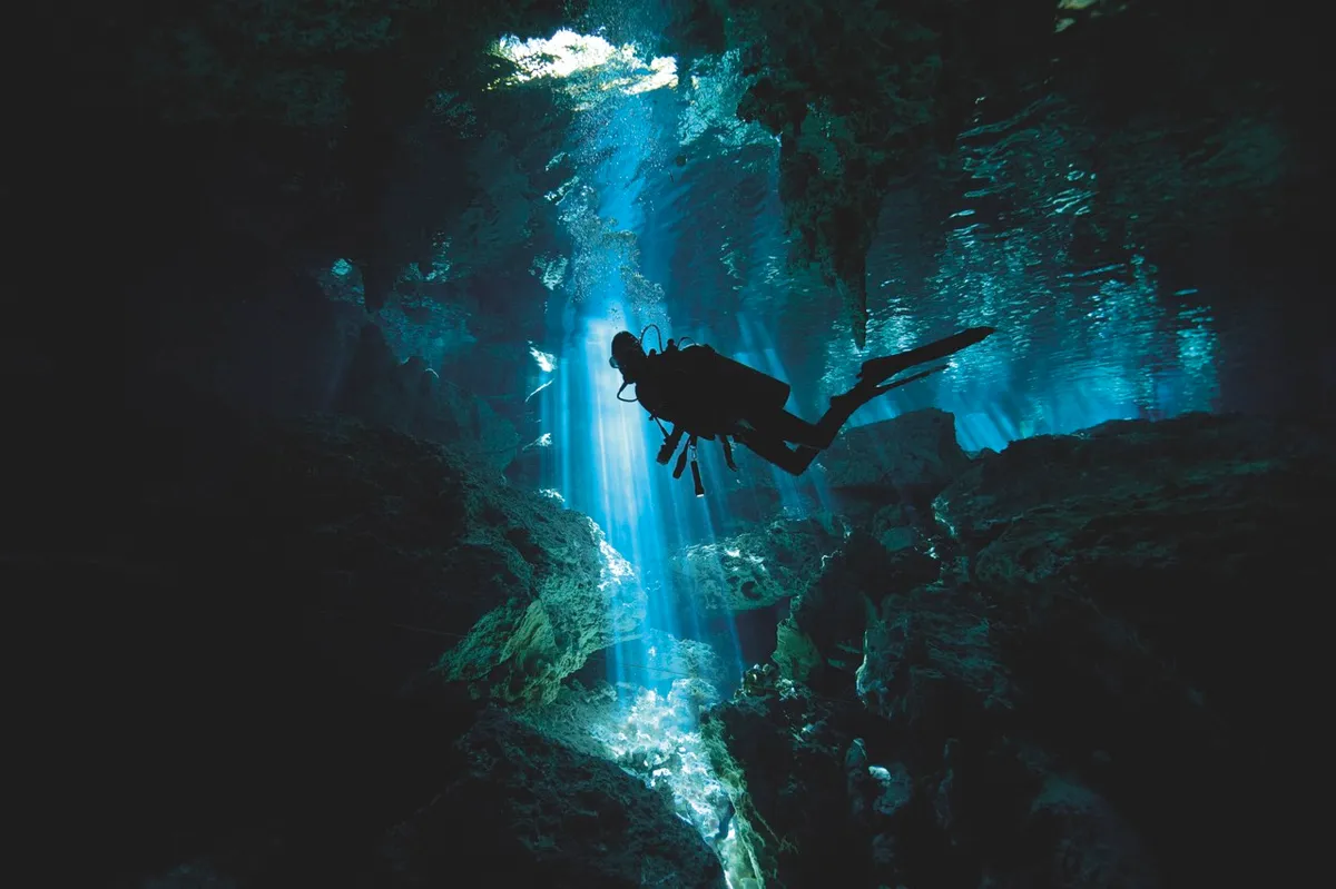Scuba diver inside cenote in Mexico © Alastair Pollock Photography/Getty Images Scuba diver inside cenote in Mexico © Alastair Pollock Photography/Getty Images