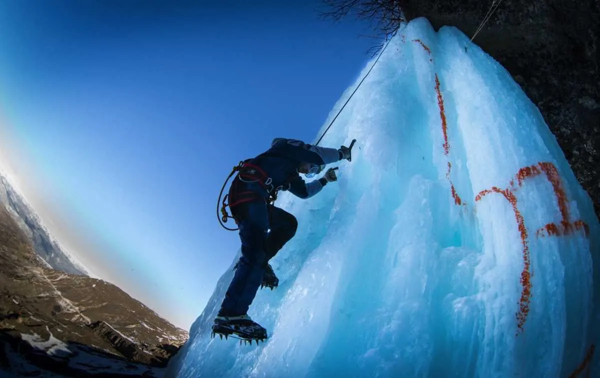 An ice climber ascends a frozen waterfall in Dagestan, Russia, during an ice climbing competition © Stanislav KrasilnikovTASS via Getty Images