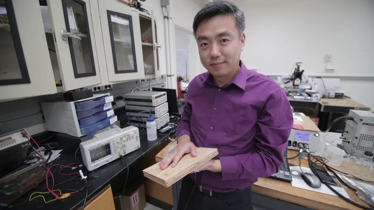 Associate Professor Xudong Wang holds a prototype of the researchers’ energyharvesting technology, which uses wood pulp and harnesses nano fibers © Stephanie Precourt/UW-Madison College of Engineering