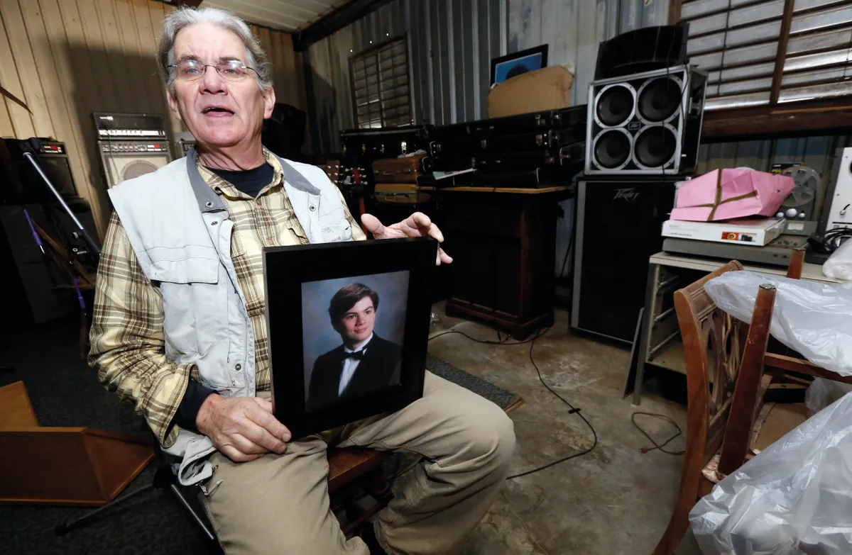 Michael Usry Sr with a picture of his then 19-year-old son. Usry Jr was vilified online as a murderer due to partial DNA evidence, but was later found innocent © Shutterstock