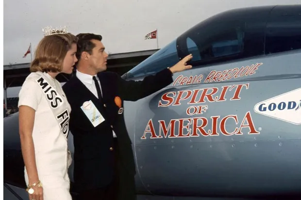 Craig Breedlove shows the cockpit of his “Spirit of America” to Miss Florida during pre-race activities for the Daytona 500 NASCAR Cup race at Daytona International Speedway (ISC Images & Archives via Getty Images)