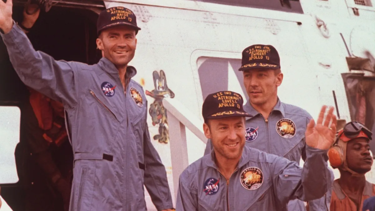 Apollo 13 astronauts Fred Haise, Jim Lovell & Jack Swigert waving as they emerge from rescue helicopter after ill-fated moon mission (© Time Life Pictures/NASA/The LIFE Picture Collection/Getty Images)