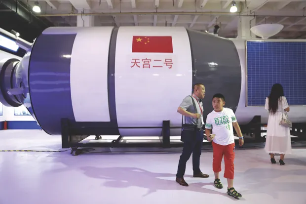 Visitors walk in front of a replica of Tiangong-2 space laboratory on display at the China Beijing International High-Tech Expo (CHITEC) in Beijing, China, 08 June 2017 © How Hwee Young/EPA/REX/Shutterstock