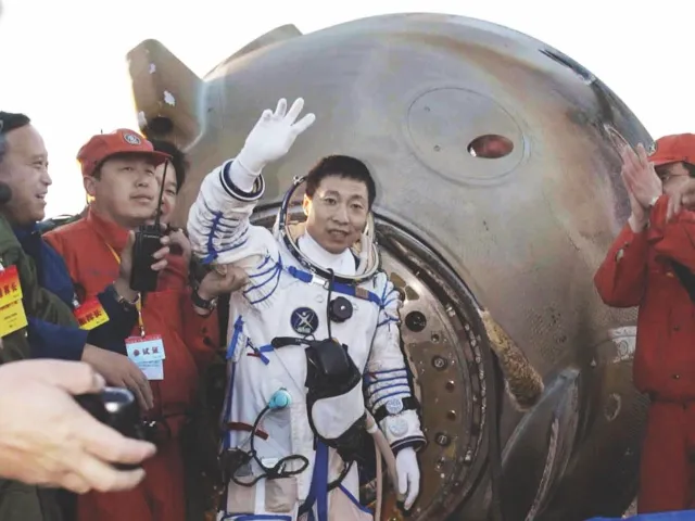 Yang Liwei, the first Chinese astronaut (also called a taikonaut), waves to the crowds after stepping out of the Shenzhou-5 re-entry capsule in October 2003 © Getty Images