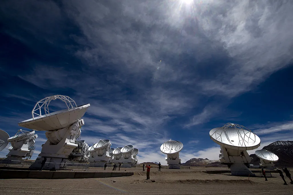 View of a Radio telescope antennas of the ALMA ( Atacama Large Millimeter/submillimeter Array) project, in the Chajnantor plateau, Atacama desert, some 1500 km north of Santiago, on March 12,2013. The ALMA, an international partnership project of Europe, North America and East Asia with the cooperation of Chile, is presently the largest astronomical project in the world. On Wednesday March 13 will be opened 59 high precision antennas, located at 5000 of altitude in the extremely arid Atacama desert. AFP PHOTO/Martin BERNETTI (Photo credit should read MARTIN BERNETTI/AFP/Getty Images)