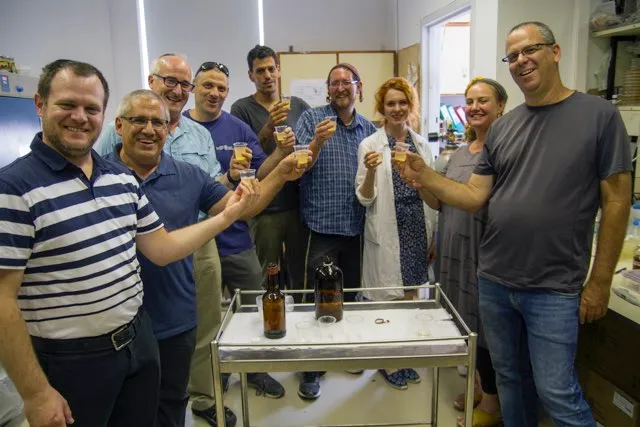 L'chaim! The Israeli research team samples their ancient brew. © Yaniv Berman, Israel Antiquities Authority.