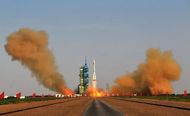 A Long March 2F rocket carrying Shenzhou-9 manned spacecraft blasts off from the Jiuquan Satellite Launch Center on June 16, 2012 in Jiuquan, China. The Shenzhou-9 manned spacecraft carrying three crew members was launched at 6:37 p.m. (1037 GMT) to perform the country's first manned space docking mission with the orbiting Tiangong-1 unmanned space lab, which was launched last September. (Photo by VCG/VCG via Getty Images)