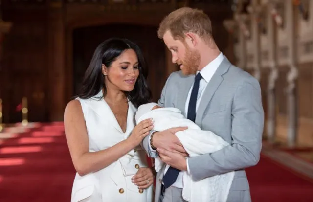 Prince Harry, Duke of Sussex and Meghan, Duchess of Sussex, pose with their newborn son Archie Harrison Mountbatten-Windsor during a photocall in St George's Hall at Windsor Castle on May 8, 2019 in Windsor, England. The Duchess of Sussex gave birth at 05:26 on Monday 06 May, 2019. (Photo by Dominic Lipinski - WPA Pool/Getty Images)