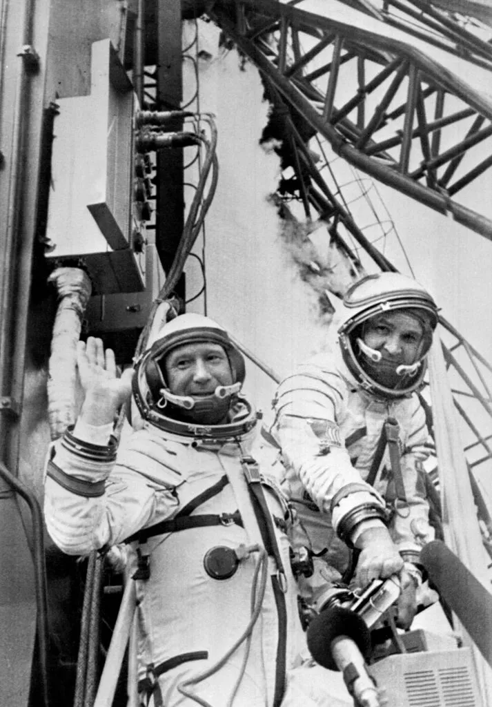 Russian cosmonauts commander Alexei Leonov (L) and V. Kubasov wave to the people while getting in their spaceship Soyuz ready to be launched 15 July 1975 from Baikonur in Kazakhstan © AFP/Getty Images