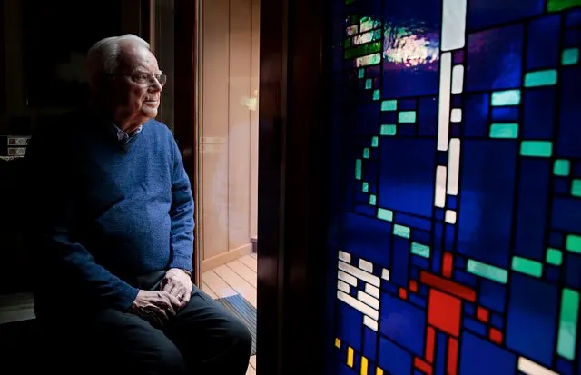 Dr Frank Drake next to a stained glass window with the Arecibo Message © Ramin Rahimian for The Washington Post via Getty Images