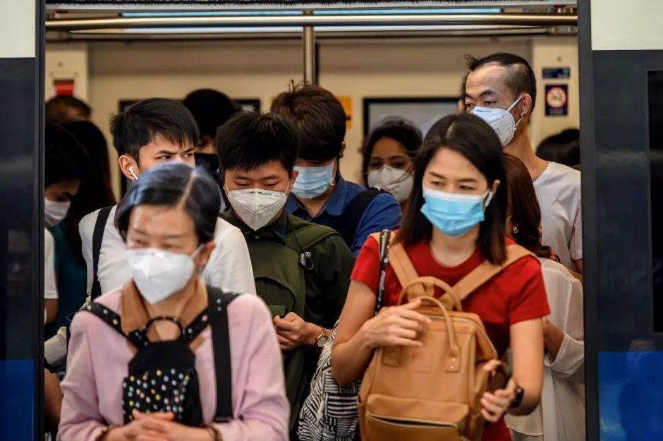 People wear face masks on a train in Bangkok, Thailand © Getty Images