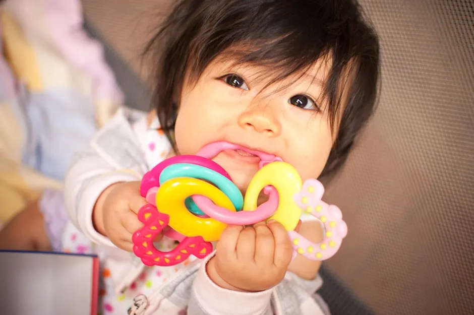 Baby chewing a toy © Getty Images