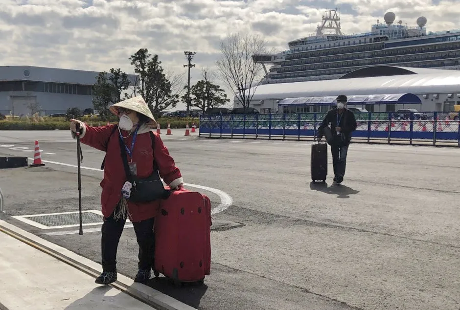 Passengers are leaving the Diamond Princess cruise liner, operated by Carnival Corp, after a two-week coronavirus quarantine in the port of Yokohama © Igor BelyayevTASS via Getty Images