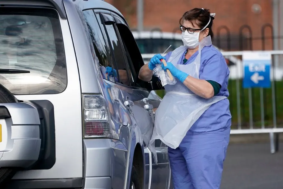 A member of the public is swabbed at a drive through Coronavirus testing site, set up in a car park in Wolverhampton © Christopher Furlong/Getty Images