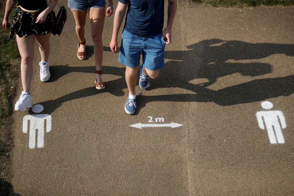 People walk past the social distancing markings on the ground at Queen Elizabeth Olympic Park in London © Alex Pantling/Getty Images