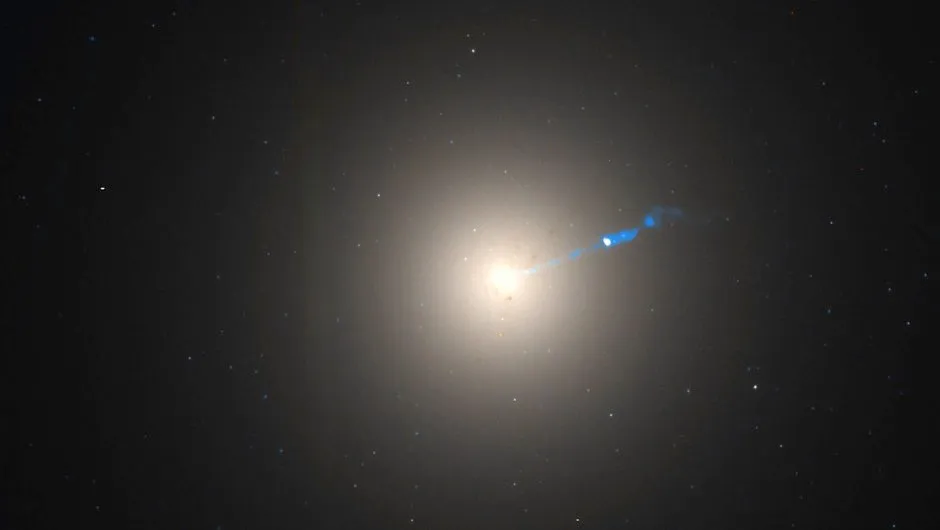 The blue stream of material is being ejected from a black hole at the centre of the M87 galaxy © NASA