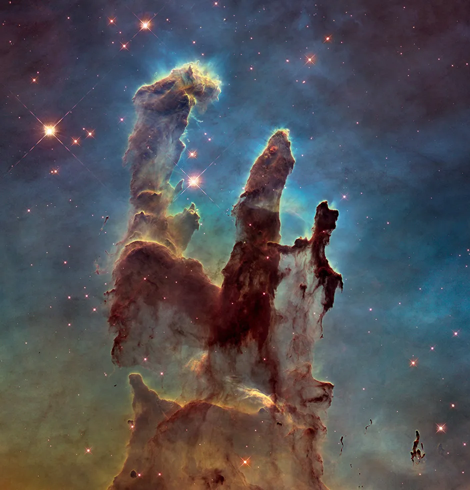 This image of the Pillars of Creation in the Eagle Nebula was taken by Hubble’s newer Wide Field Camera 3 in 2014. To give an idea of scale, the towering pillars are about five light-years tall © NASA, ESA and the Hubble Heritage Team (STScI/AURA)