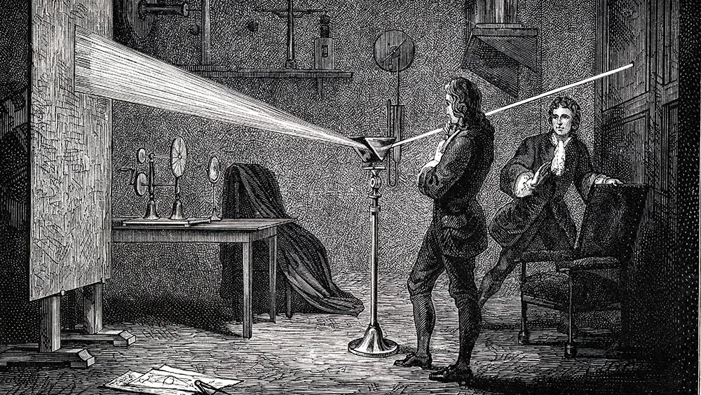 Isaac Newton using a prism to break white light into the visible spectrum © Getty Images