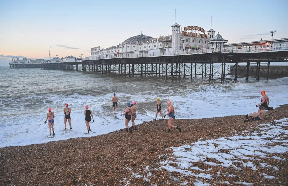 Swimmers at Brighton Pier shun wetsuits in order to maximise the benefits of the chilly water © Alamy