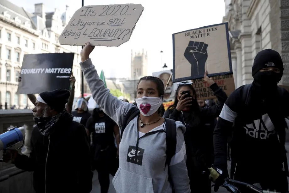 Protesters walk up Downing Street after gathering in Parliament Square to commemorate the life of George Floyd at 5pm, the time when his body will be laid to rest in Houston, Texas, where he grew up, on June 09, 2020 in London, United Kingdom. The death of an African-American man, George Floyd, while in the custody of Minneapolis police has sparked protests across the United States, as well as demonstrations of solidarity in many countries around the world. (Photo by Dan Kitwood/Getty Images)