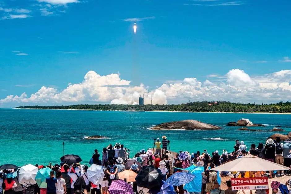 People watch the rocket launch from the Wenchang Space Launch Centre © STR/AFP via Getty Images