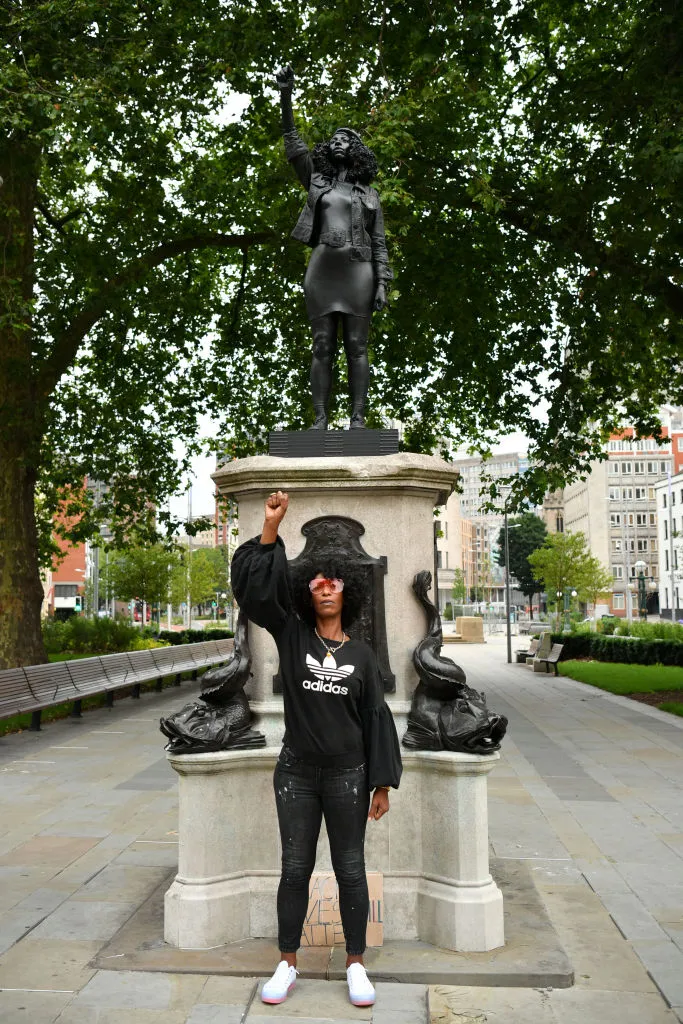 Black Lives Matter protester Jen Reid stands in front of the statue of her which briefly stood on the plinth formerly occupied by Edward Colston © Getty Images