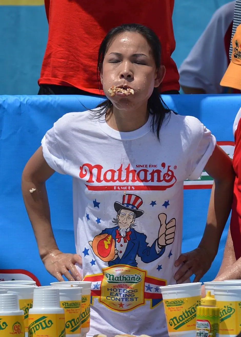 Women’s Hot Dog Eating World Championship, Sonya “The Black Widow” Thomas during Nathan’s Famous Fourth of July International Hot Dog Eating Contest July 4, 2012 in the Coney Island section of New York. Thomas won by eating 45 hot dogs and buns in ten minutes. AFP PHOTO/Stan HONDA (Photo credit should read STAN HONDA/AFP/GettyImages)