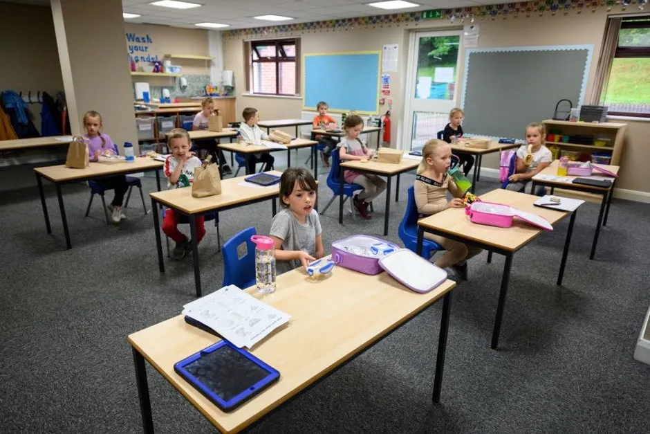 Key Stage 1 pupils in academic years 1 and 2 eat their lunches individually at their desks, sitting well apart from each other in order to minimise the risk of passing on Coronavirus at Willowpark Primary Academy in Oldham, north-west England on June 18, 2020, as primary schools to recommence education for Reception, Years 1 and Year 6 classes, alongside priority groups. (Photo by OLI SCARFF / AFP) (Photo by OLI SCARFF/AFP via Getty Images)